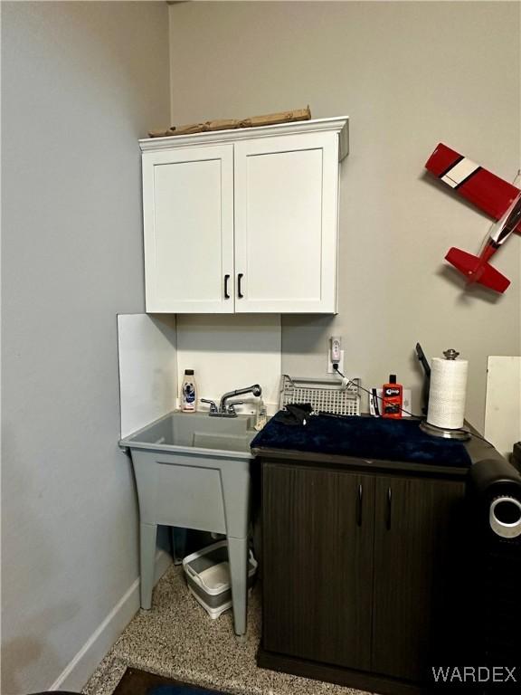 laundry area with baseboards