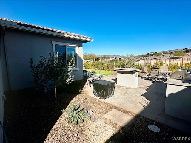 view of patio with fence and area for grilling