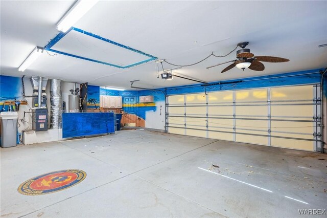 garage with water heater, heating unit, and a garage door opener