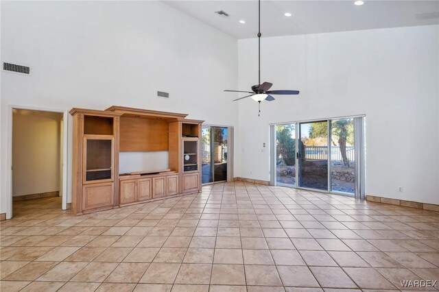 unfurnished living room with baseboards, visible vents, and light tile patterned flooring