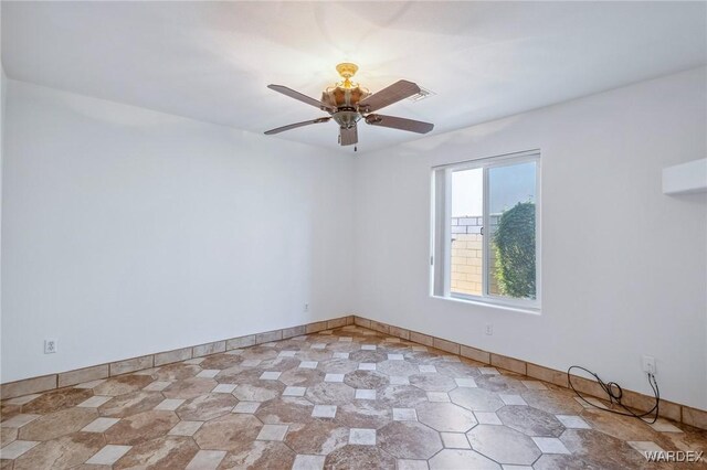 empty room with baseboards and a ceiling fan