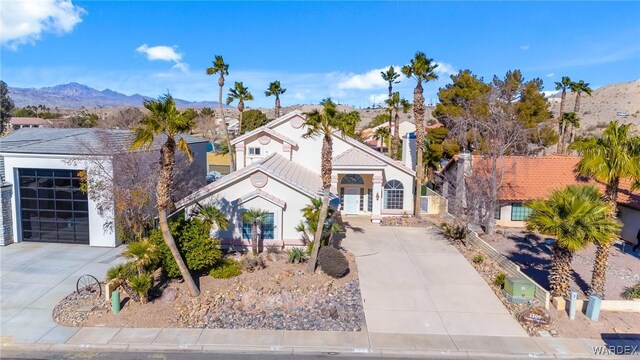 view of front of property with a garage, driveway, and a mountain view