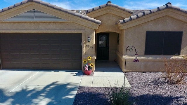 6246 S Vista Laguna Dr, Fort Mohave, AZ 86426 - view of front of property featuring a garage, a tile roof, concrete driveway, and stucco siding