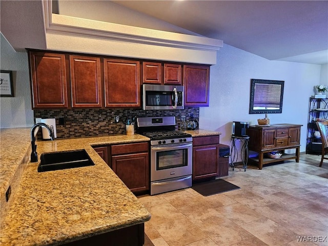 6246 S Vista Laguna Dr, Fort Mohave, AZ 86426 - kitchen with a sink, tasteful backsplash, vaulted ceiling, light stone counters, and appliances with stainless steel finishes