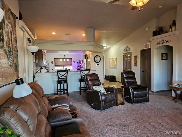 6246 S Vista Laguna Dr, Fort Mohave, AZ 86426 - carpeted living area with vaulted ceiling, visible vents, and a ceiling fan