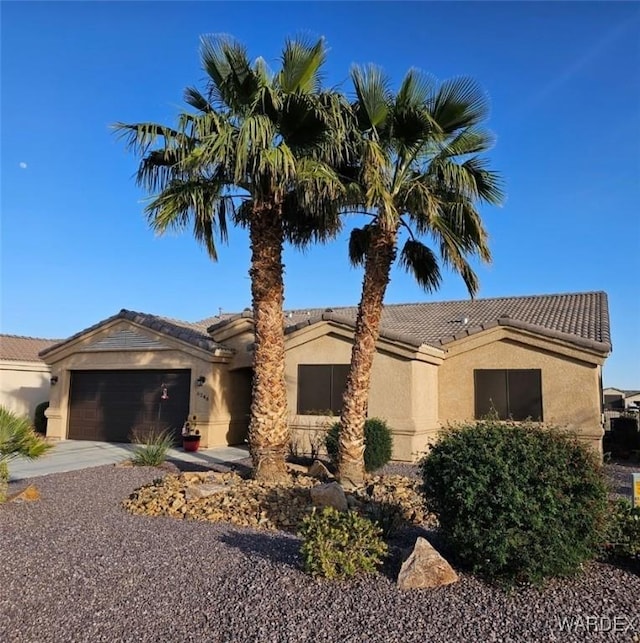 6246 S Vista Laguna Dr, Fort Mohave, AZ 86426 - single story home with an attached garage, a tile roof, concrete driveway, and stucco siding
