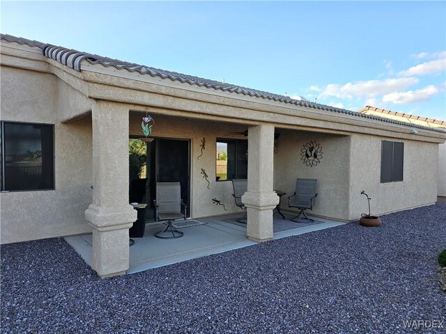 6246 S Vista Laguna Dr, Fort Mohave, AZ 86426 - rear view of house featuring stucco siding, a patio area, and a tiled roof