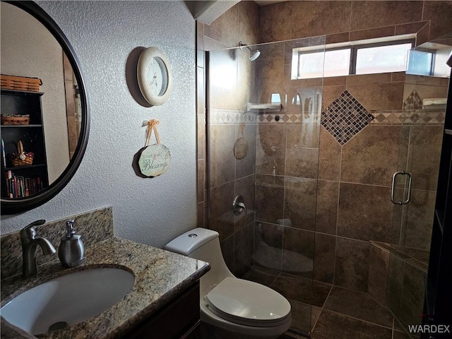 6246 S Vista Laguna Dr, Fort Mohave, AZ 86426 - full bathroom with a shower stall, toilet, vanity, and a textured wall