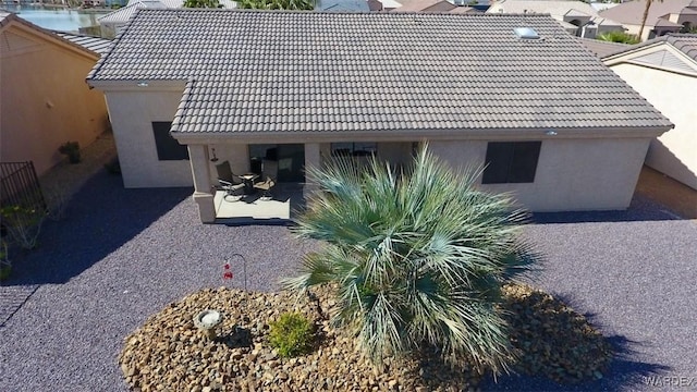6246 S Vista Laguna Dr, Fort Mohave, AZ 86426 - view of side of home with stucco siding, a tile roof, and a patio area