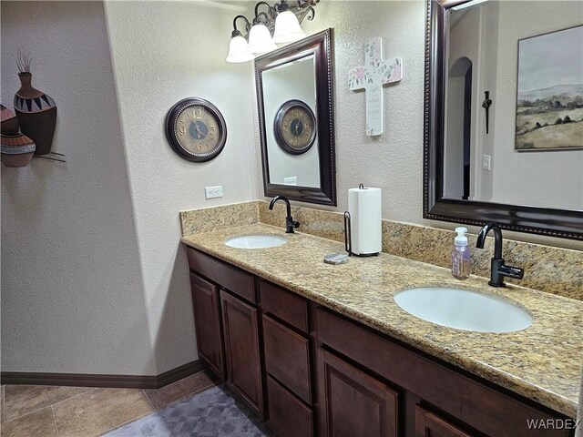 6246 S Vista Laguna Dr, Fort Mohave, AZ 86426 - full bath with double vanity, tile patterned flooring, baseboards, and a sink
