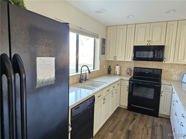 6246 S Vista Laguna Dr, Fort Mohave, AZ 86426 - kitchen with tasteful backsplash, a sink, black appliances, cream cabinets, and dark wood-style flooring