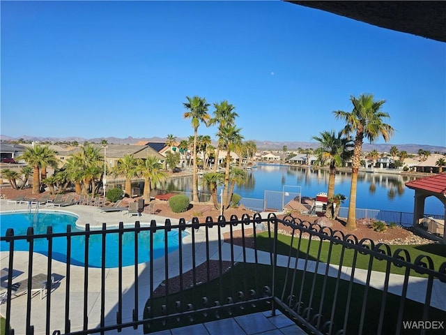 6246 S Vista Laguna Dr, Fort Mohave, AZ 86426 - pool featuring a residential view, a patio, fence, and a water and mountain view