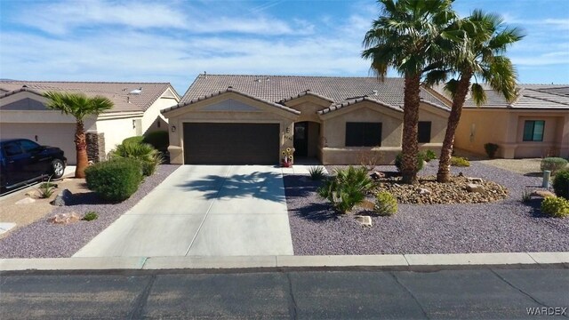 6246 S Vista Laguna Dr, Fort Mohave, AZ 86426 - ranch-style house featuring concrete driveway, an attached garage, a tiled roof, and stucco siding