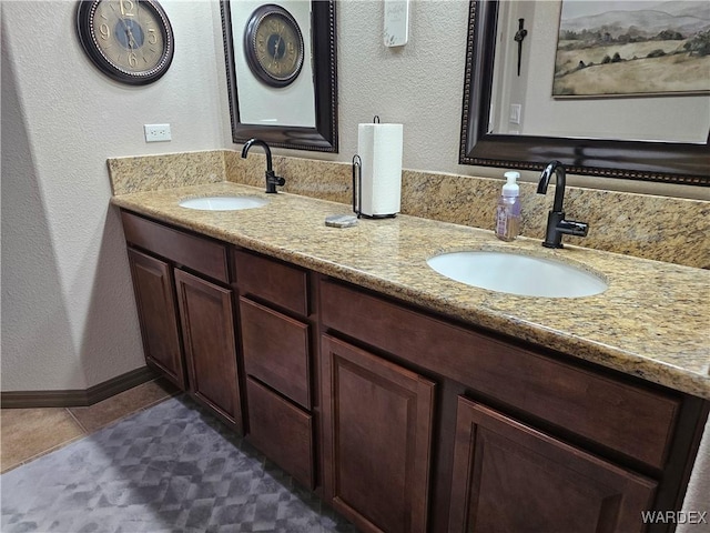 6246 S Vista Laguna Dr, Fort Mohave, AZ 86426 - bathroom with baseboards, a textured wall, a sink, and double vanity