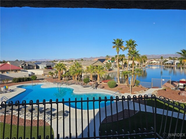 6246 S Vista Laguna Dr, Fort Mohave, AZ 86426 - community pool with a residential view, a patio, fence, and a water and mountain view