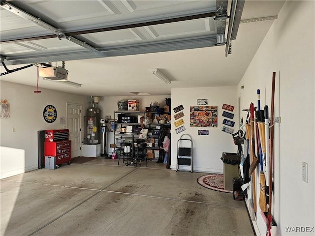 6246 S Vista Laguna Dr, Fort Mohave, AZ 86426 - garage with baseboards, gas water heater, and a garage door opener
