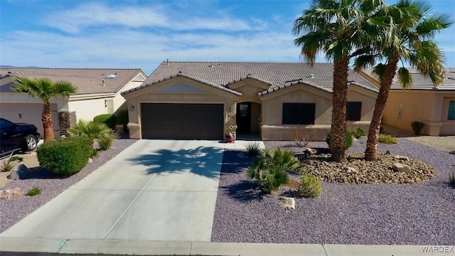 6246 S Vista Laguna Dr, Fort Mohave, AZ 86426 - ranch-style home featuring concrete driveway, an attached garage, a tiled roof, and stucco siding