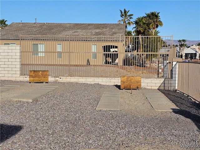 6246 S Vista Laguna Dr, Fort Mohave, AZ 86426 - back of house featuring fence, roof with shingles, and board and batten siding