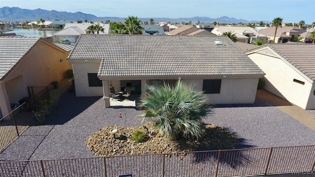 6246 S Vista Laguna Dr, Fort Mohave, AZ 86426 - view of front of house with fence, a tiled roof, a residential view, stucco siding, and a mountain view