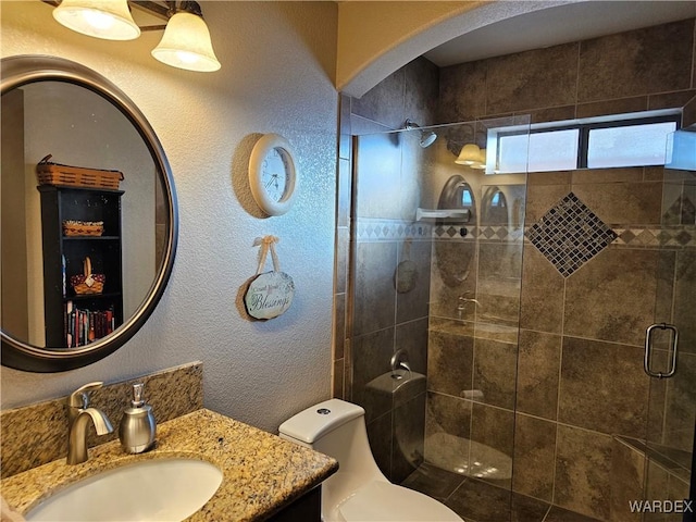 6246 S Vista Laguna Dr, Fort Mohave, AZ 86426 - bathroom featuring a textured wall, vanity, a shower stall, and toilet