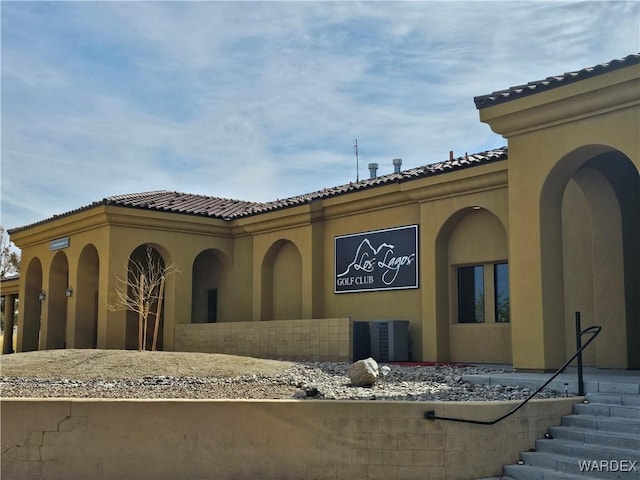 6246 S Vista Laguna Dr, Fort Mohave, AZ 86426 - exterior space featuring a tile roof, central AC, and stucco siding