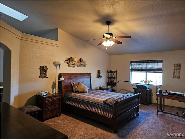 6246 S Vista Laguna Dr, Fort Mohave, AZ 86426 - carpeted bedroom featuring a ceiling fan, arched walkways, and vaulted ceiling with skylight