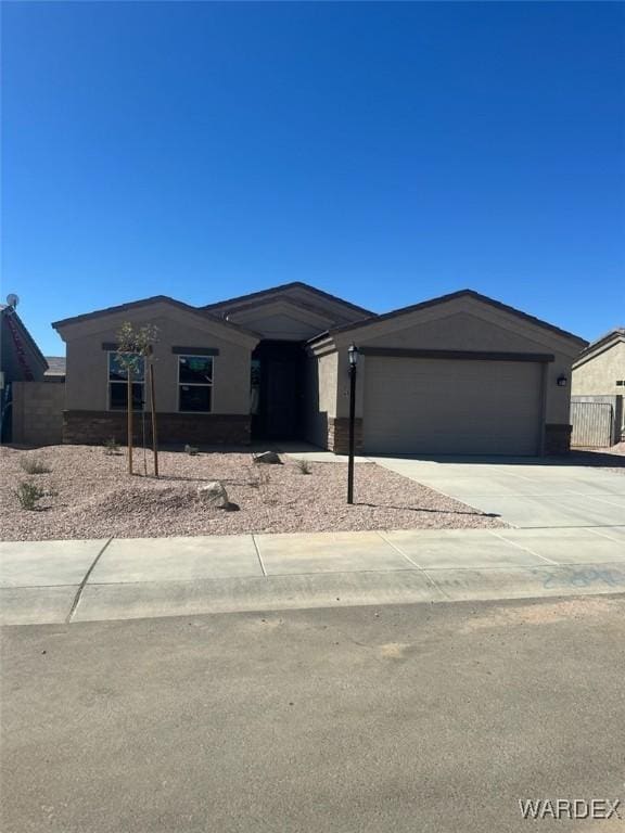 view of front of property featuring concrete driveway and an attached garage