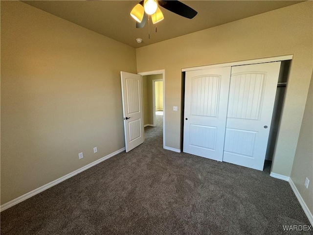 unfurnished bedroom featuring dark colored carpet, a closet, and baseboards