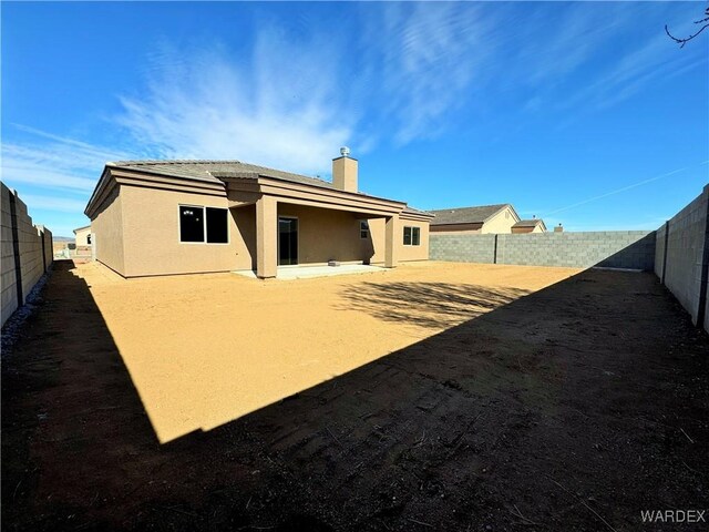 back of property with a patio, a fenced backyard, and stucco siding