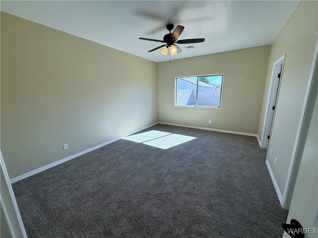 spare room featuring ceiling fan, baseboards, visible vents, and dark colored carpet