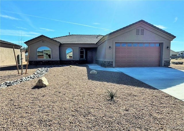 ranch-style home with driveway, a garage, stone siding, a tile roof, and stucco siding