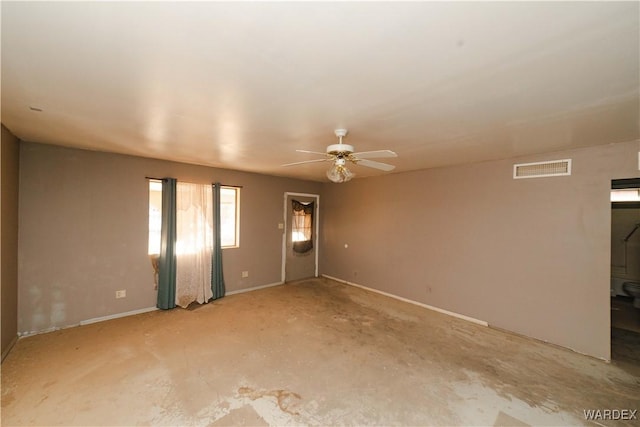 unfurnished room with visible vents and ceiling fan