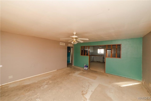 unfurnished living room with baseboards, concrete floors, visible vents, and a ceiling fan