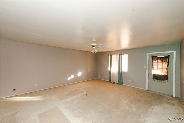 empty room featuring concrete floors and a ceiling fan