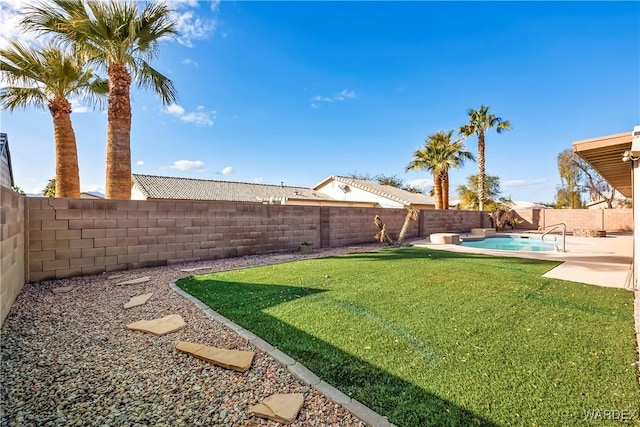 view of yard featuring a patio area, a fenced backyard, and a fenced in pool