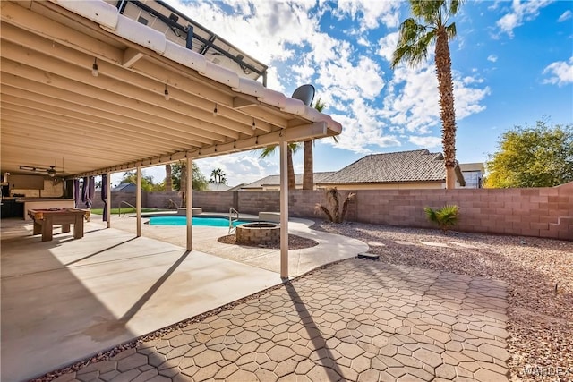 view of pool featuring a patio area, a fenced backyard, a fire pit, and a fenced in pool