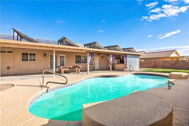 view of swimming pool with fence, a fenced in pool, and a patio