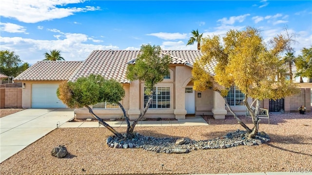 view of front of house with a garage, concrete driveway, a tiled roof, and stucco siding