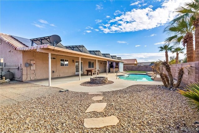 view of pool featuring a fire pit, a patio, and a fenced backyard