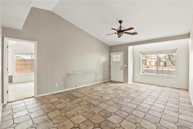 entrance foyer featuring ceiling fan, high vaulted ceiling, baseboards, and a healthy amount of sunlight