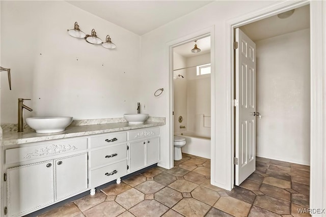 full bath featuring tub / shower combination, a sink, toilet, and double vanity