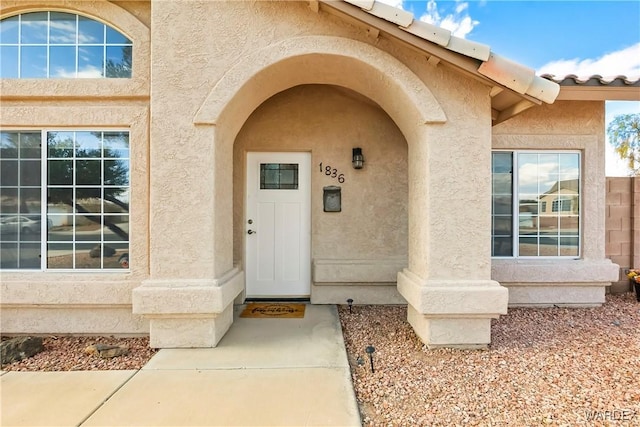 doorway to property with stucco siding