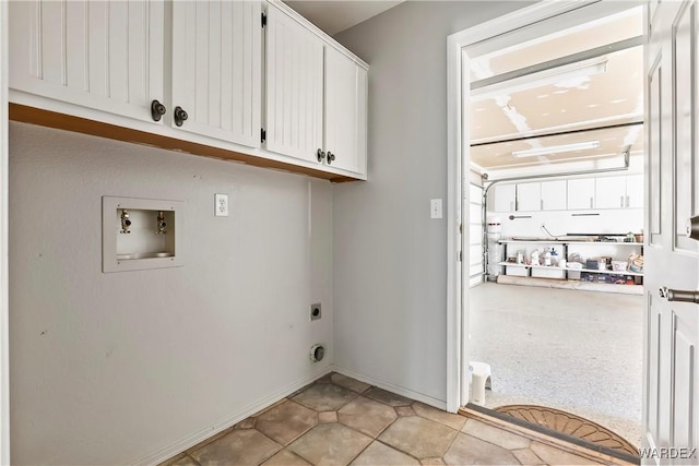 washroom with washer hookup, hookup for an electric dryer, cabinet space, and baseboards