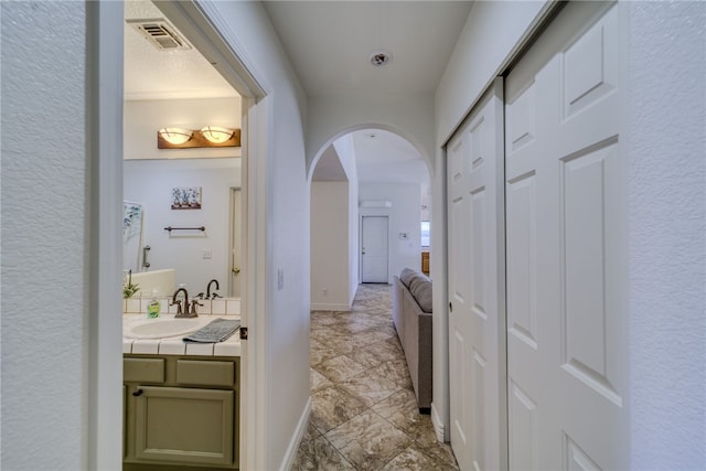 2041 E Sundance Dr, Fort Mohave, AZ 86426 - hallway with a sink and arched walkways