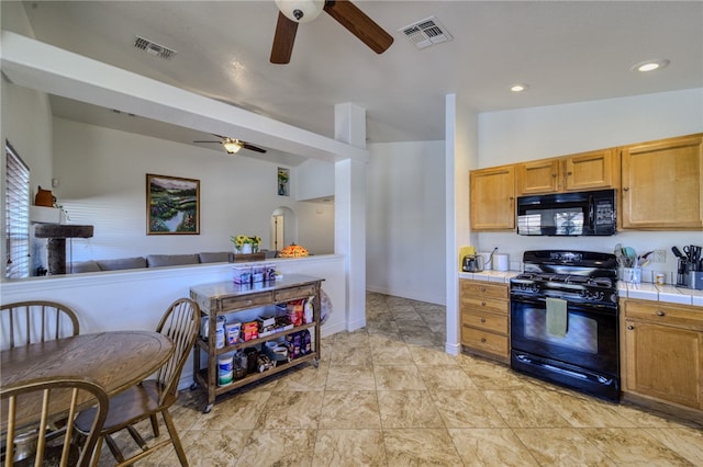 2041 E Sundance Dr, Fort Mohave, AZ 86426 - kitchen with black appliances, a ceiling fan, tile countertops, and open floor plan