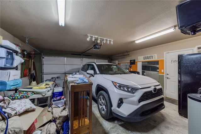 2041 E Sundance Dr, Fort Mohave, AZ 86426 - garage featuring freestanding refrigerator and a garage door opener