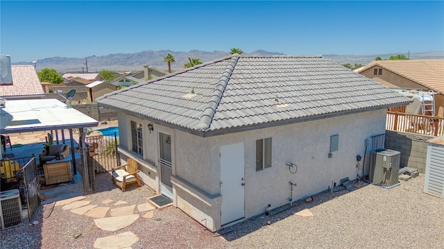 2041 E Sundance Dr, Fort Mohave, AZ 86426 - rear view of house with a tile roof, stucco siding, and a mountain view