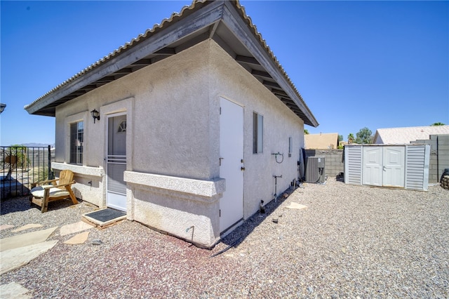 2041 E Sundance Dr, Fort Mohave, AZ 86426 - view of property exterior with a storage unit and stucco siding