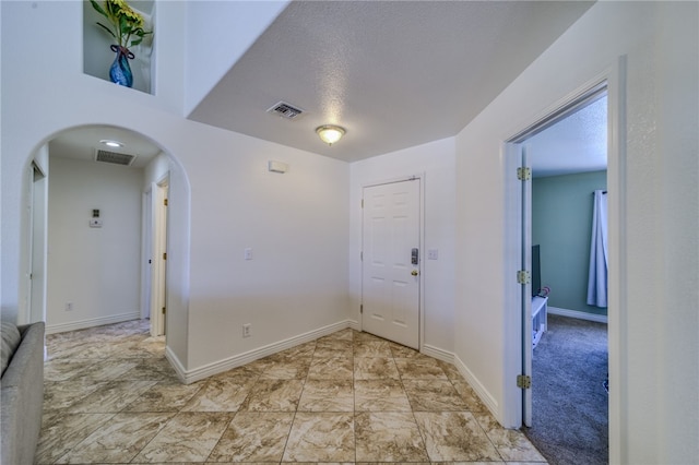 2041 E Sundance Dr, Fort Mohave, AZ 86426 - spare room featuring arched walkways and a textured ceiling