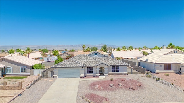 2041 E Sundance Dr, Fort Mohave, AZ 86426 - single story home featuring a tiled roof, driveway, a residential view, an attached garage, and stucco siding